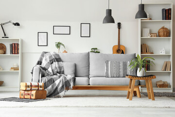 Poster - interior of stylish living room with grey sofa, houseplants and shelving units
