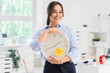 © Pixel-Shot - Businesswoman holding clock with text MANAGE YOUR TIME in office