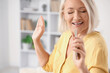 © Pixel-Shot - Mature woman with mobile phone singing at home, closeup