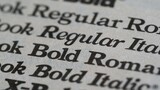 A close up shot of different font styles and weights on a white paper with a shallow depth of field