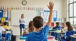© PLATİNUM - A young boy raises his hand to answer a question in a lively classroom environment.
