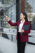 © NINENII - Lifestyle of office workers, Woman successful standing front of a modern office building.