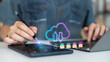 © K2LStudio - Person using tablet stylus and laptop with cloud computing icon, secure login interface, and file transfer concept for digital storage and data technology.