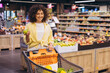 © anatoliycherkas - Young Woman Choosing Fresh Fruit While Grocery Shopping in Supermarket