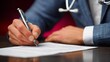 © mbah - Doctor's Hand Signing Medical Document at Desk in Clinic Office