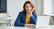 © MST - Confident Woman Working Professionally at Her Desk with a Laptop