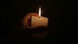 © karthik - Photorealistic Closeup of a Hand Gently Cupping a Lit Candle, a Symbol of Hope, Comfort, and Solace in Darkness