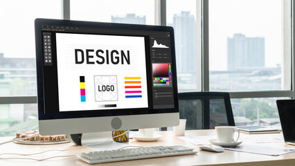 Graphic designer software for modern design of web page and commercial ads showing on the computer screen