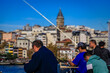 © SvetlanaSF - Artistic blurred fishermen on Galata Bridge, popular pastime in Istanbul, Turkey