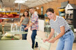 © JackF - Girl buyer before buying furniture inspects chair goods for defects and flaws. Customer in garden furniture store inspects countertop and imagine product in patio