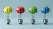 © creative - Colorful brains inside light bulbs standing on blue background