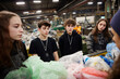 © Box Milk - Morning in a recycling center filled with bags and bins Teens are learning how to separate waste materials properly