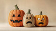 © Pedro - A trio of carved pumpkins, each with a unique expression, ready for Halloween. The pumpkins are displayed against a neutral background.