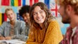 © Alena - Group of international students engaged in a cheerful language conversation class, sitting around a table with American and French flags, enjoying multicultural learning in a modern classroom.
