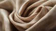 © Haris - Close-up of luxurious, draped, light taupe fabric.  Soft folds and subtle sheen