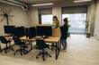 © Roman - Modern Office With People Collaborating and Computers in a Creative Workspace