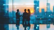 © Ta stodio - Silhouettes of three professionals conversing against a sunset backdrop in a modern office setting, highlighting collaboration and business dynamics.