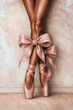 © DELstudio - Elegant close-up of ballerina legs in pink pointe shoes with oversized satin bows, feminine aesthetic, soft beige background, stylish art concept