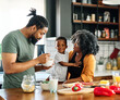 © Lumos sp - Portrait of mother, father and son  preparing and eating breakfast in the kitchen at home