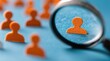 © Qohhar - Magnifying glass focuses on one orange person figure amidst many white and orange figures