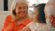 © Monkey Business - Granddaughter Cuddling With Loving Grandparents On Sofa At Home
