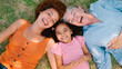 © Monkey Business - Overhead Portrait Shot Of Multi-Generation Female Family Lying On Grass