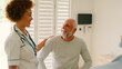 © Monkey Business - Female Nurse Wearing Uniform Reassuring Senior Male Patient In Private Hospital Room