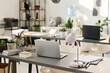 © TrueFrame Collective - No people shot of part of modern office interior with laptop and lamp on desk, copy space