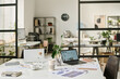 © TrueFrame Collective - Selective focus interior shot of modern office with laptops, computers and papers on desks, copy space