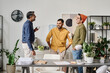 © TrueFrame Collective - Group of three cheerful South Asian male office workers chatting during coffee break time