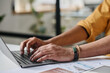 © TrueFrame Collective - Closeup of unrecognizable mans hands typing on laptop at work in modern office, copy space
