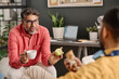 © TrueFrame Collective - Selective focus shot of cheerful mature Indian manager talking to colleague during break time in office