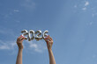 © ADDICTIVE STOCK - Hands holding silver 2026 balloons against clear sky