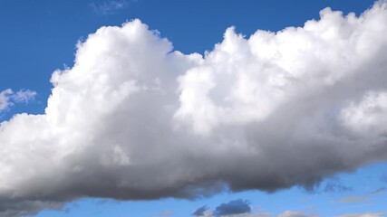 Wall Mural - enormus radiant cumulonimbus clouds move in the blue sky
