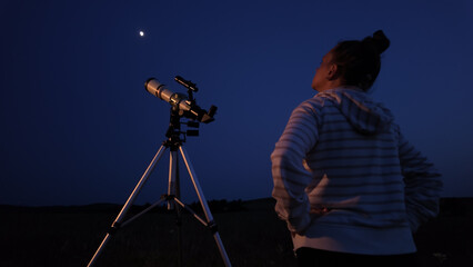 Wall Mural - amateur astronomer using telescope for watching stars, moon, planets and other celestial objects fro