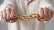© mazeo - Hands holding a golden chain