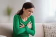 © Prazis Images - Woman experiencing intense chest pain from a possible heart attack