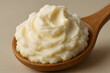 © LooPanda-Pictures - Creamy Mash: Close-up shot of a delectable scoop of smooth, creamy mashed potato elegantly presented on a wooden spoon, a culinary delight.