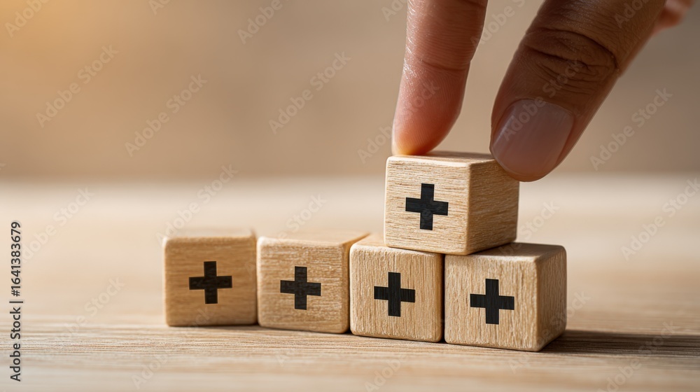 Stock-Foto „Building Success: Hand Stacking Wooden Blocks with Plus ...
