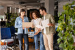 © Maria Vitkovska - Marketing team working together analyzing strategy on laptop and documents