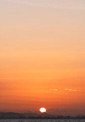 Wall Mural - sun dawn vertical over sea mountaint in the evening, orange sunset and red sun light golden hour sky