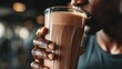 © Intie - Person drinking a chocolate smoothie