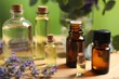 © New Africa - Bottles of essential oils and different plants on table outdoors, closeup