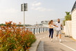 © BGStock72 - Couple enjoying a lively run along a scenic waterfront path in summer