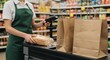 © Firman Dasmir - Supermarket Checkout Scene: Aproned Cashier Scanning Bread with Paper Grocery Bags