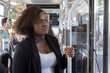 © Anna Berkut/Stocksy - woman in tramway commuting to work, public transport