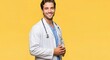© mohammed - Portrait of a handsome young doctor smiling confidently in a lab coat with a stethoscope against a vibrant yellow background