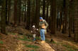 © Iuliia Versta/Stocksy - Father and son walking in autumn forest