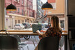 © Milles Team/Stocksy - Woman working on the table near window in coffee shop