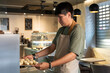 © Milles Team/Stocksy - Baker Preparing Freshly Made Pastries in a Cozy Cafe
